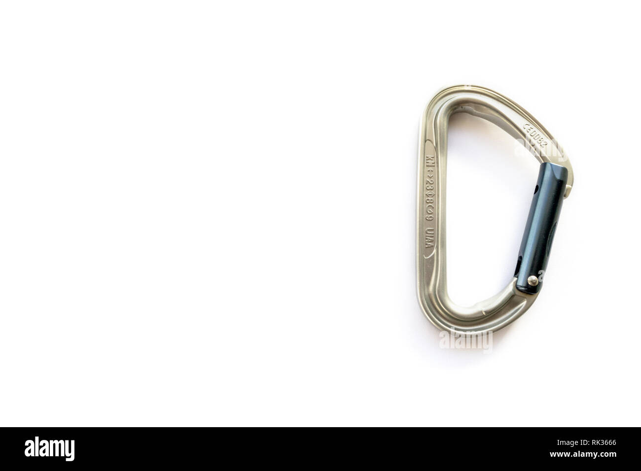 Silver solid straight gate carabiner with strength ratings, isolated on white background. Close up of non-locking binner, essential climbing gear Stock Photo