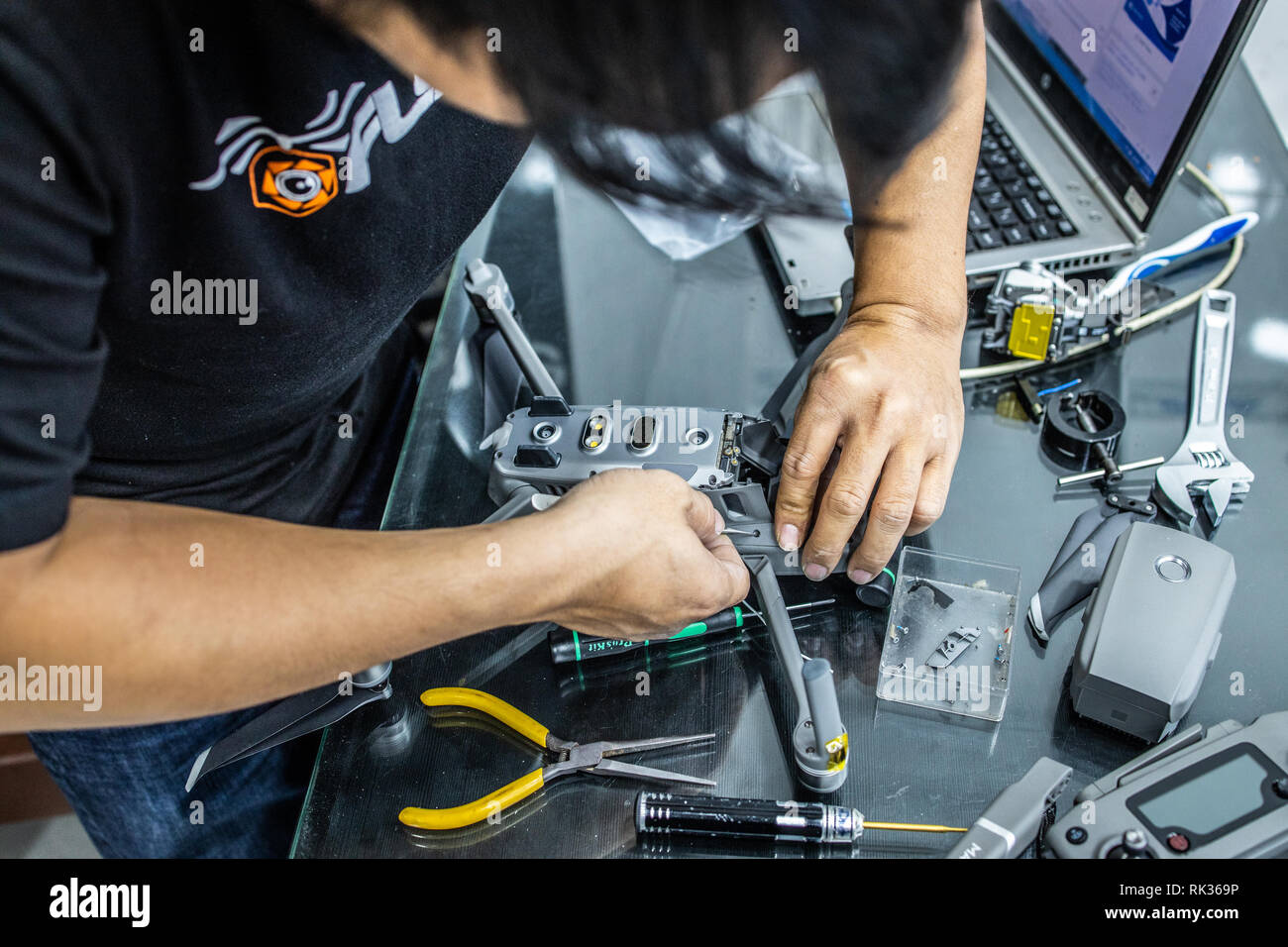 Technitian repairing a DJI Mavic 2 drone, Saigon Hobby Shop, Ho Chi Minh City or Saigon, Vietnam Stock Photo