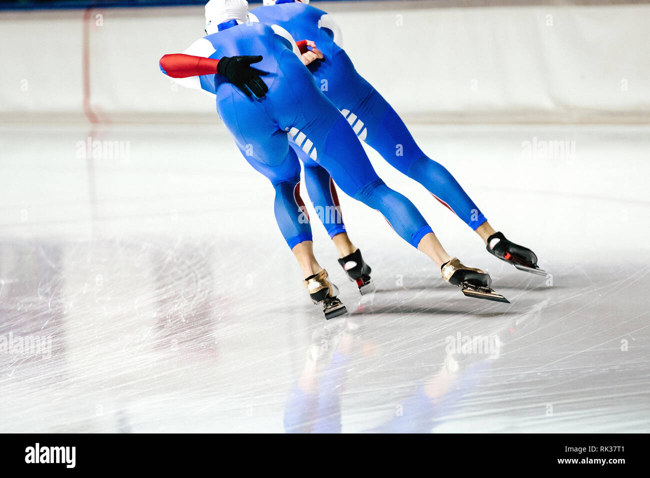back two athletes speed skaters warm up in speed skating Stock Photo