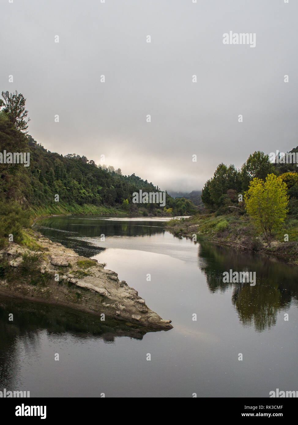 Confluence of Ahuahu Stream with Whanganui River, native forest bush clad hills, calm still autumn morning, Te Tuhi Landing, North Island, New Zealand Stock Photo