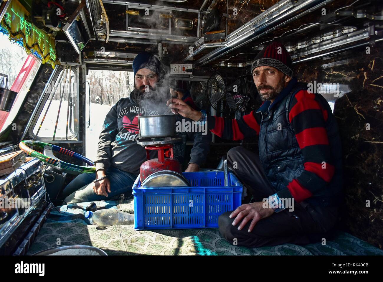 Qazigund, Kashmire, India. 09th February, 2019.Qazigund, J&K, India - Drivers are seen making tea inside their truck carrying essential supply on a closed National Highway in Qazigund, about 85kms from Srinagar, Indian administered Kashmir. The main National Highway that connects the valley with the rest of country remained closed on Saturday for the fourth consecutive day following an avalanche killing seven people including the three policemen, the two firefighters and the two prisoners. Credit: Saqib Majeed/SOPA Images/ZUMA Wire/Alamy Live News Stock Photo