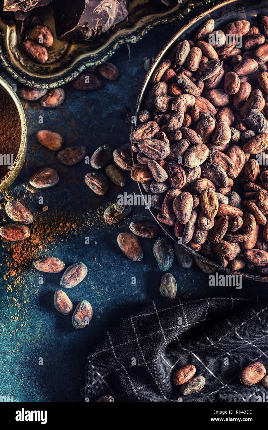 Dark chokolate cocoa beans and powder on concrete table Stock Photo