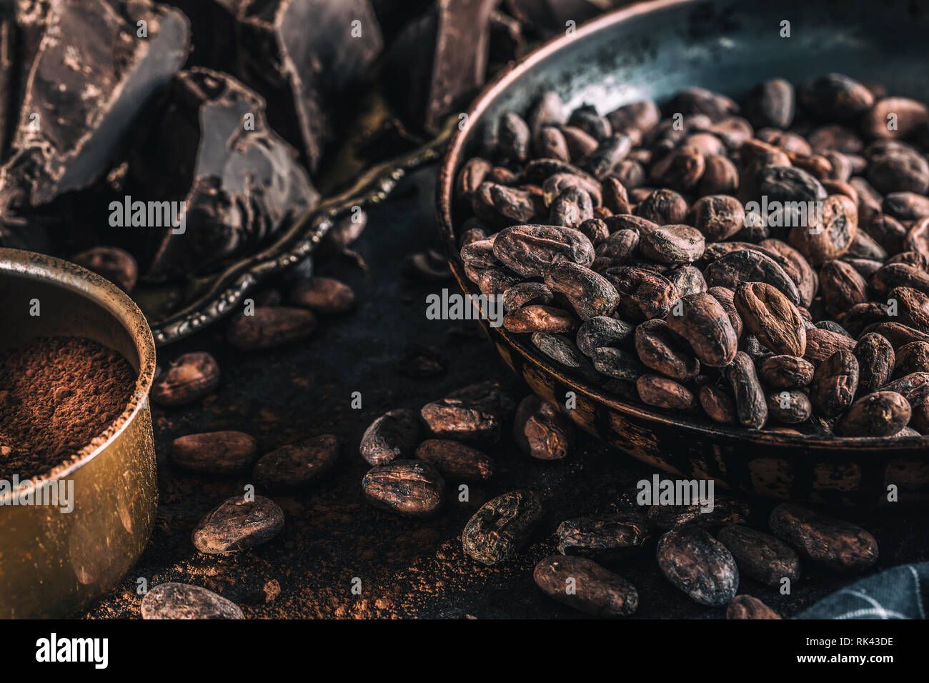 Dark chokolate cocoa beans and powder on concrete table Stock Photo