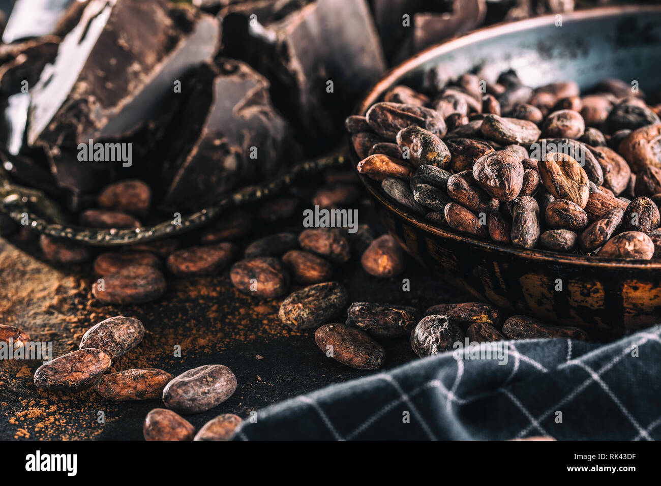 Dark chokolate cocoa beans and powder on concrete table Stock Photo