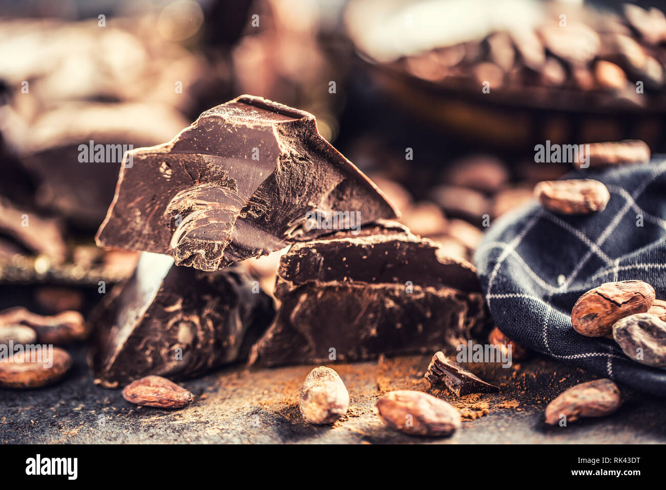 Dark chokolate cocoa beans and powder on concrete table Stock Photo