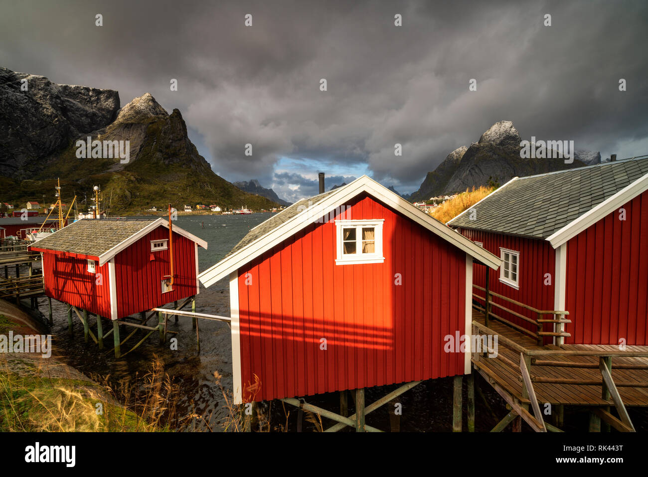 Storm clouds above the red traditional fisherman's huts (Rorbu), Reine, Nordland, Lofoten Islands, Norway Stock Photo