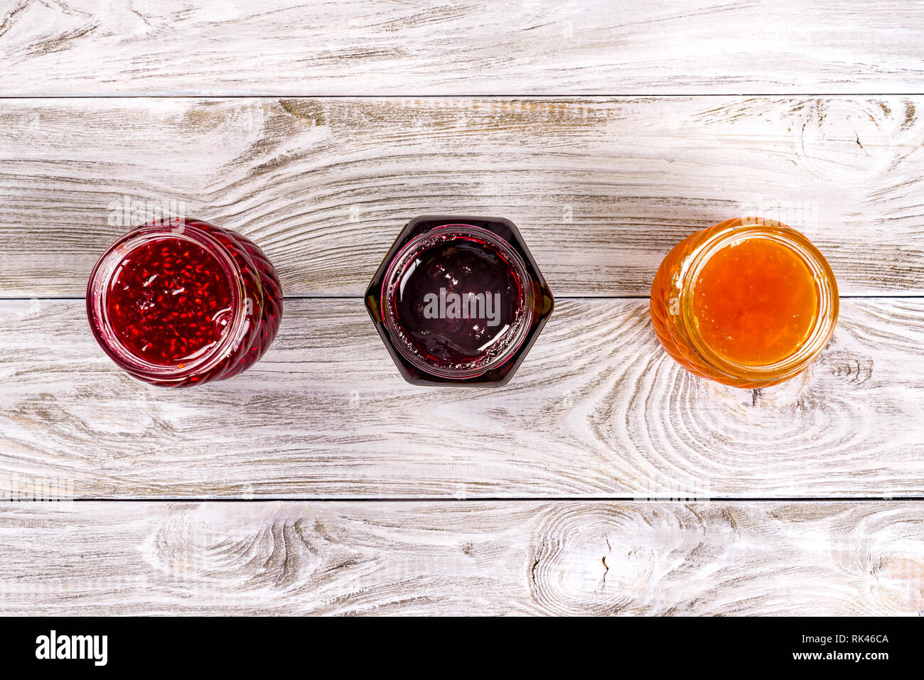Table Jam Three bowls with different jams on wooden table. Top view Stock Photo ...