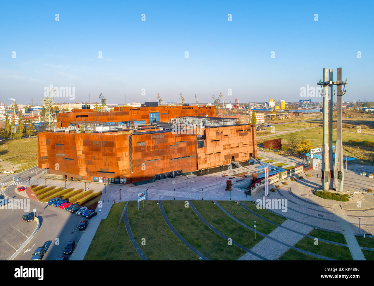 Gdańsk, Poland. Rusty steel building of European Solidarity Center and museum in Gdansk and the monument to the Fallen Shipyard Workers. Stock Photo