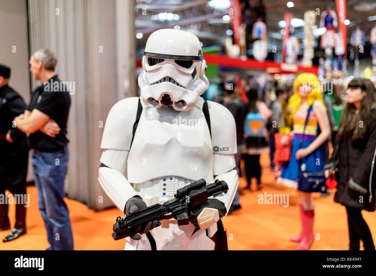 Birmingham, UK - March 17, 2018. A cosplayer dressed in a Storm Trooper costume from Star Wars movies at a comic con in Birmingham, UK pointing a gun Stock Photo