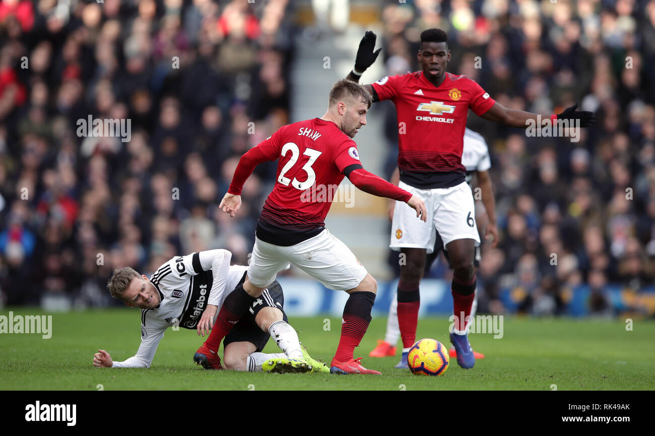 Fulham's Andre Schurrle (left) and Manchester United's Luke Shaw battle for the ball during the Premier League match at Craven Cottage, London. Stock Photo