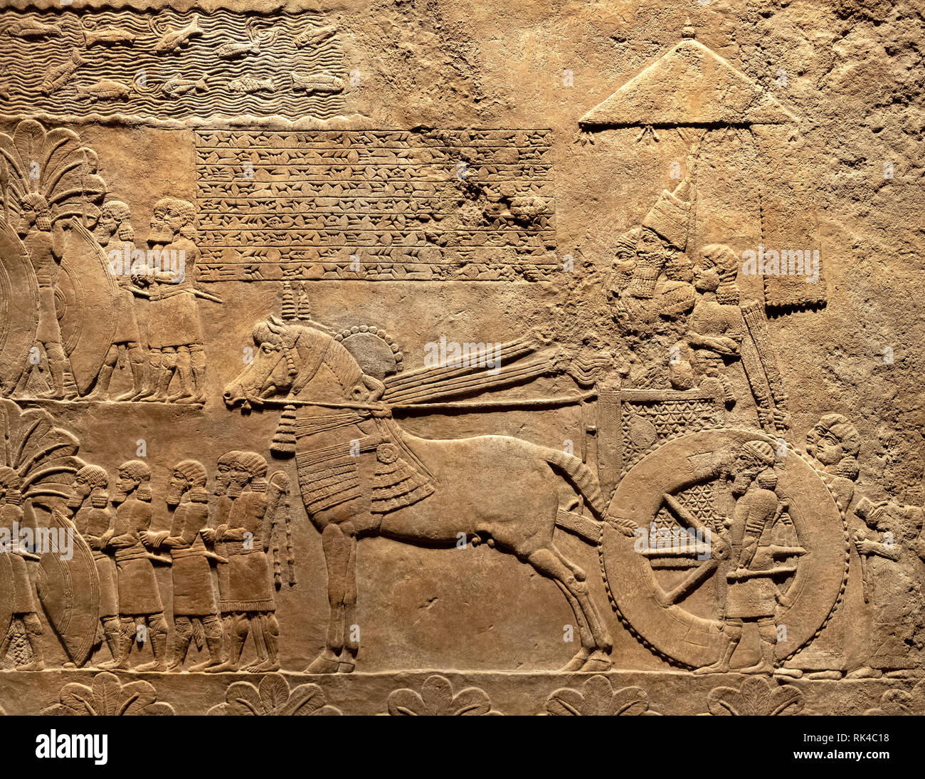 London, England / United Kingdom - 2019/01/28: Ancient Assyria clay tablet relief of king Ashurbanipal inspecting booty and prisoners from conquered B Stock Photo