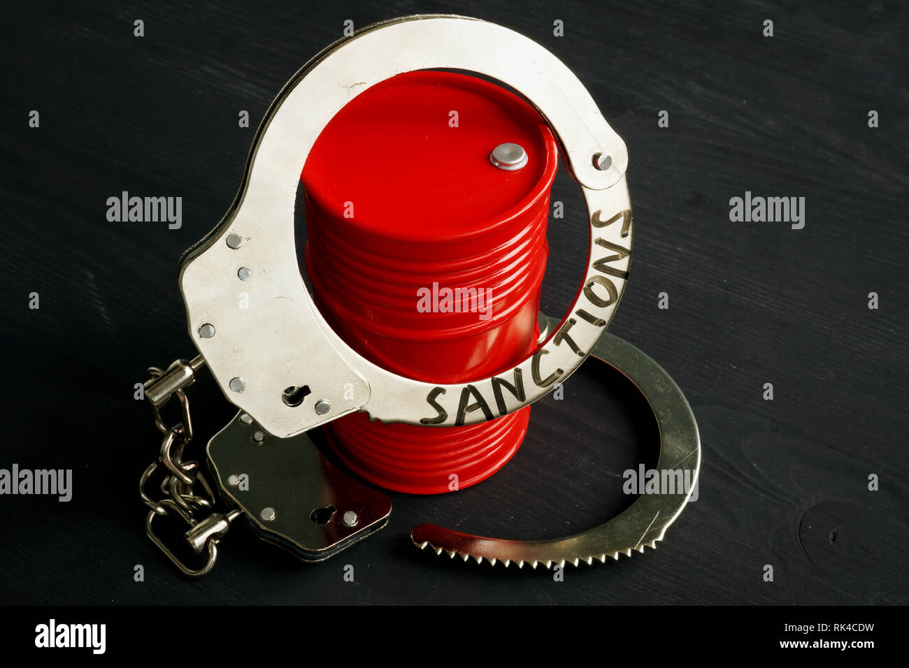 Trade embargo and sanctions concept. Barrel of oil and handcuffs. Stock Photo