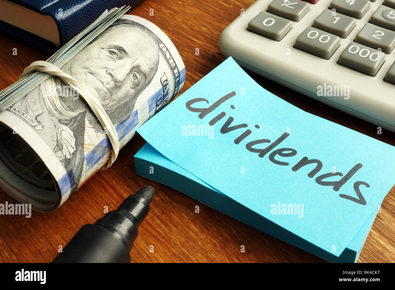 Dividends concept. Stack of dollars and calculator. Stock Photo