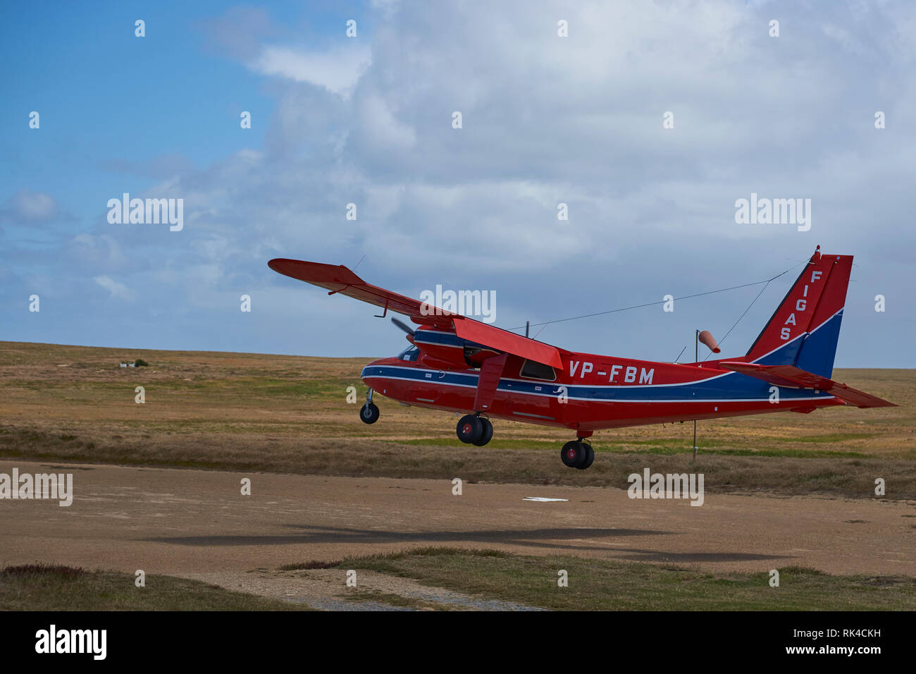 Small aircraft landing on a gravel airstrip on Sealion Island in the Falkland Islands Stock Photo