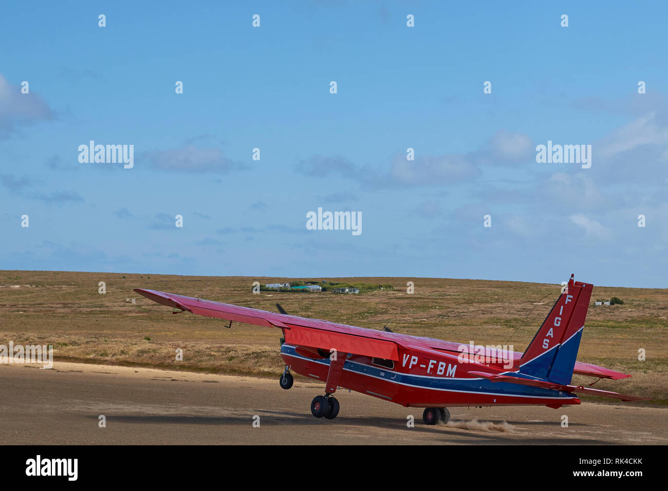 Small aircraft landing on a gravel airstrip on Sealion Island in the Falkland Islands Stock Photo