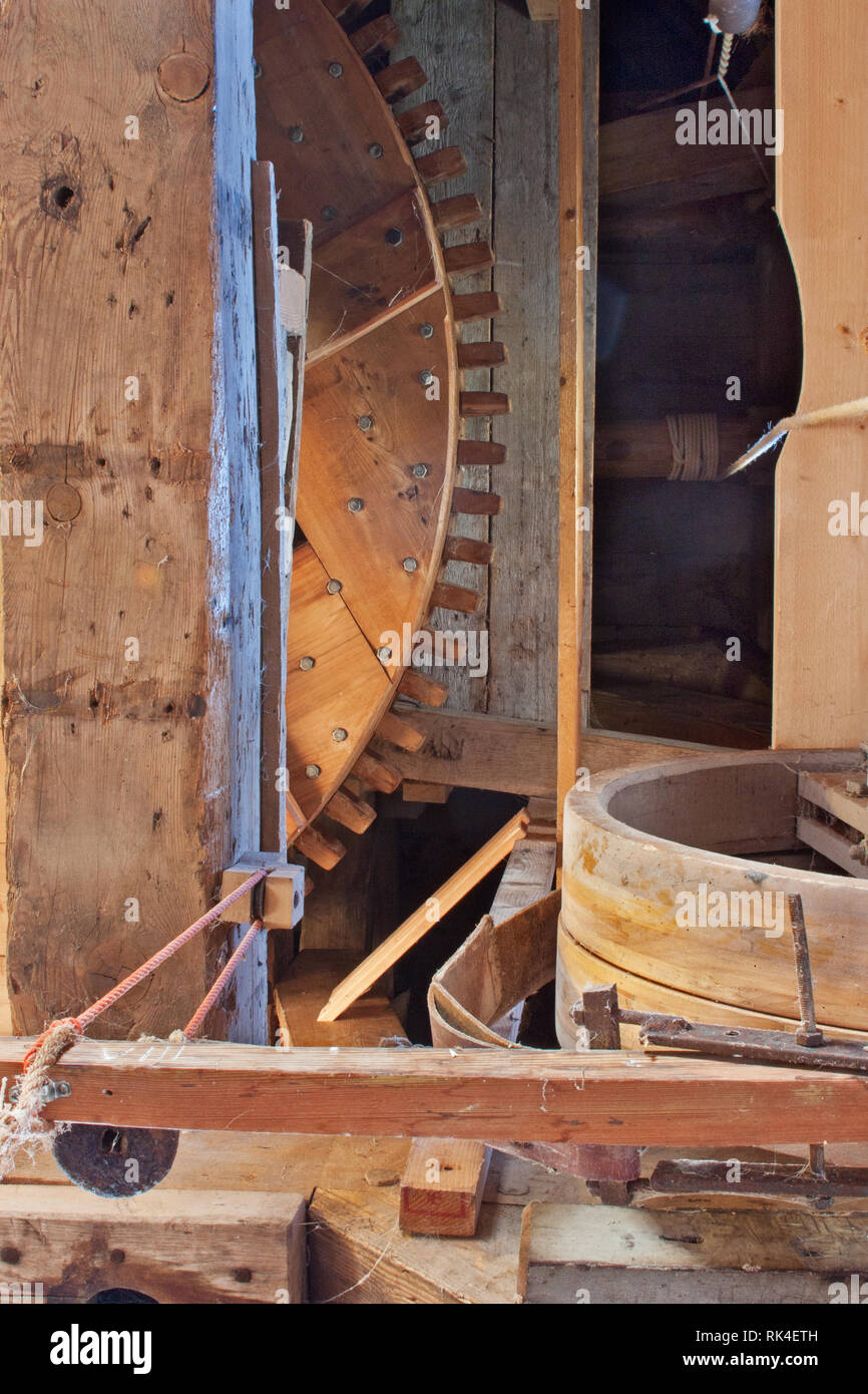 Interior and mechanism of an old wooden windmill: a big wooden sprocket Stock Photo