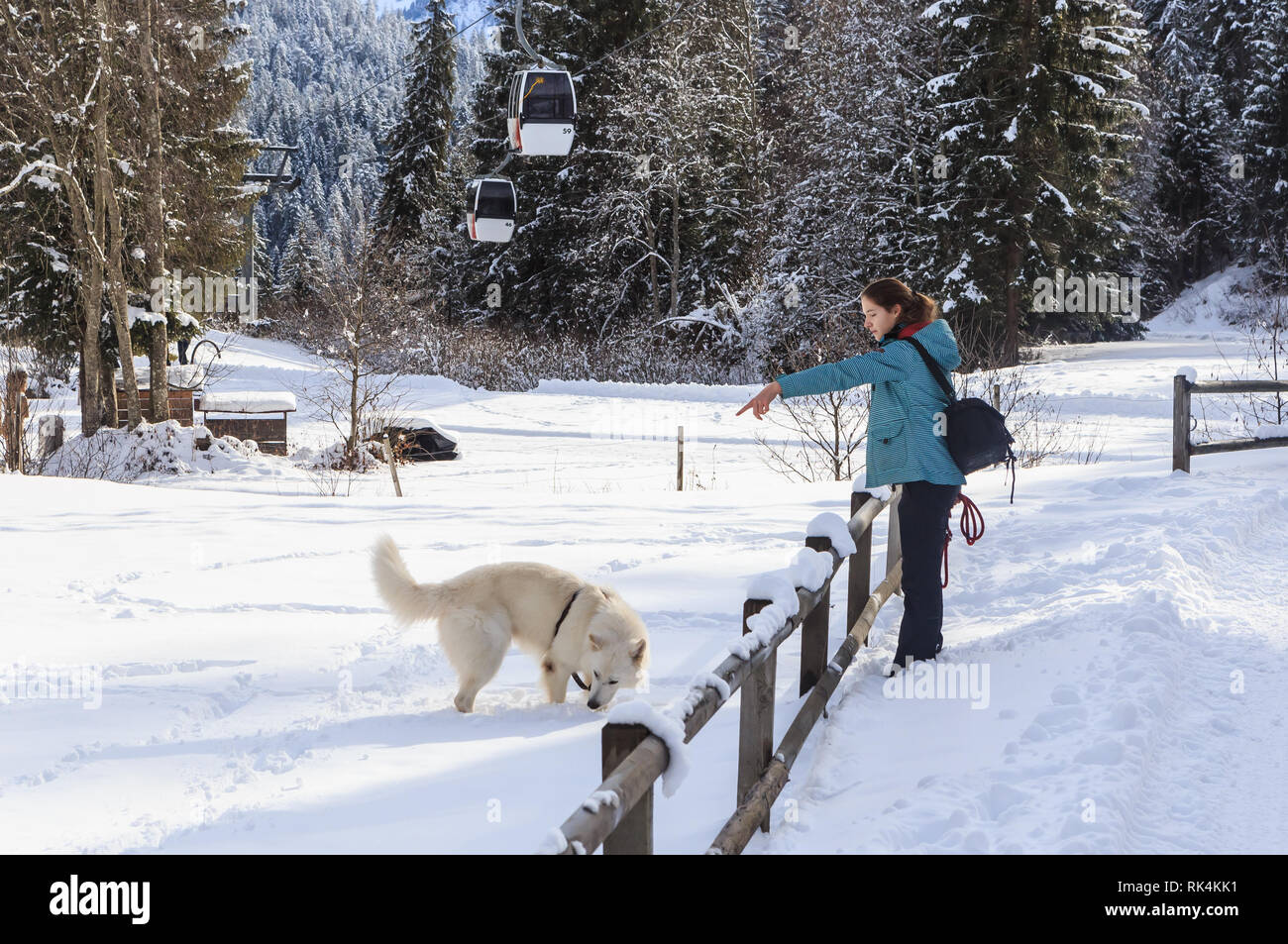 Woman training her dog.  Ski resort Laax. Switzerland Stock Photo