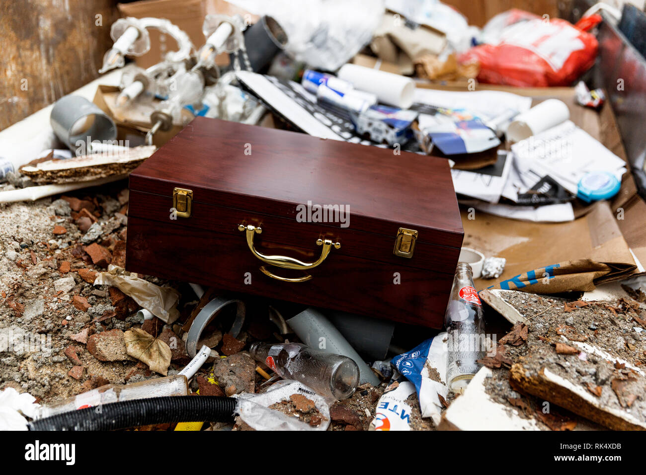 Old wooden jewellery box thrown into trash. It's always interesting the types of items you'll find in hard rubbish. Stock Photo