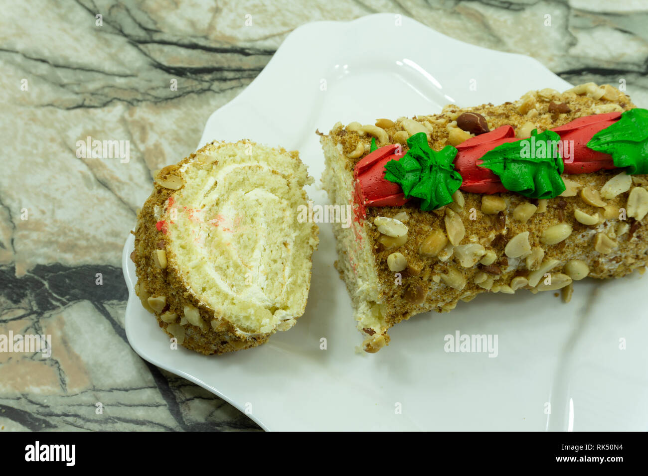 Close view of two pieces of honey cake on a plate nine layers covered with delicious sour cream and walnuts . Stock Photo