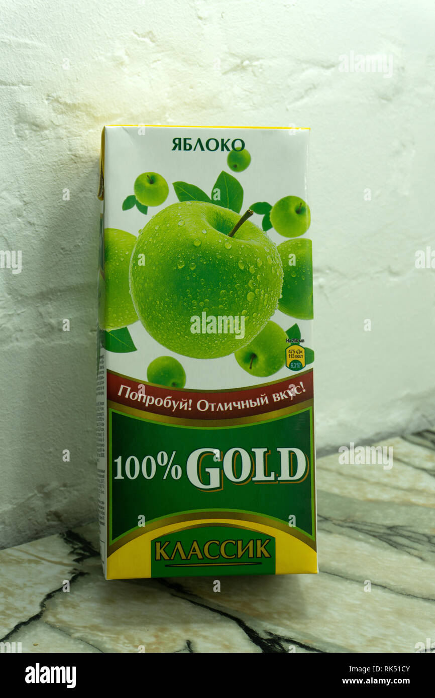 gold classic Apple and Apple juice from container isolated on whiteRussia Berezniki 12 December