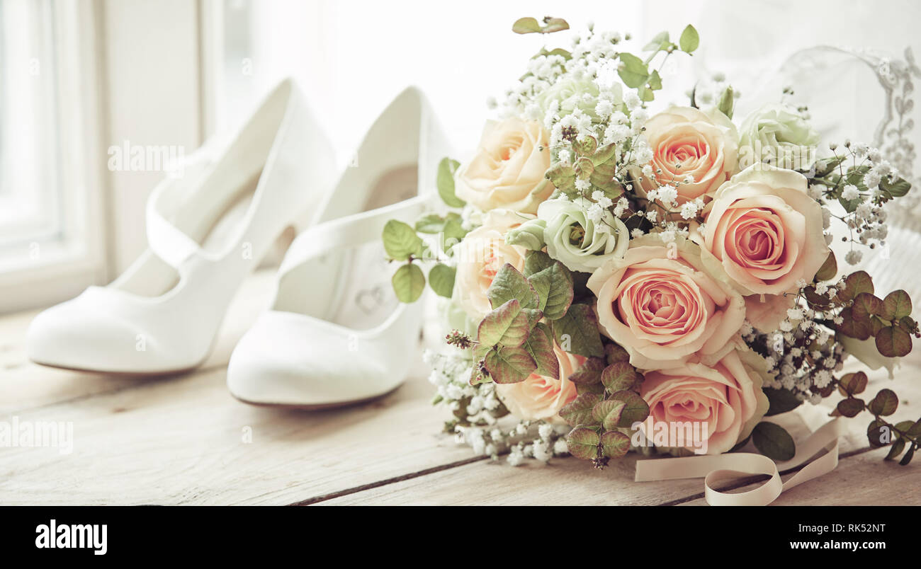 Brides White Shoes And Beautiful Wedding Bridal Bouquet Of Pink