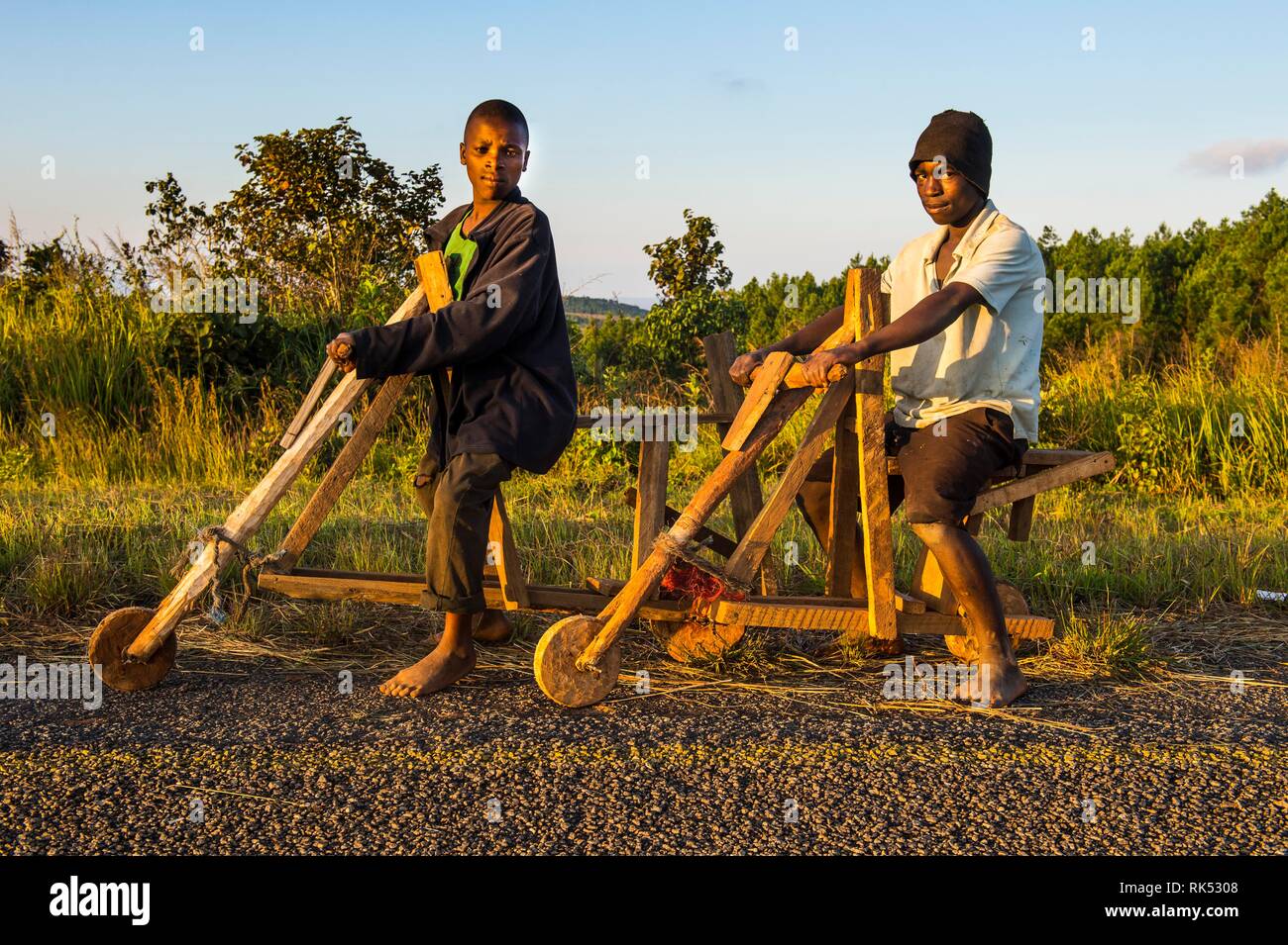 Local boys on their self made bicycles, Malawi, Africa Stock Photo