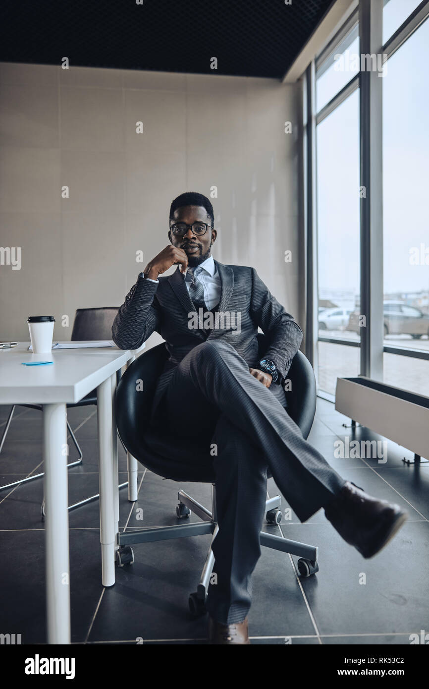confident successful handsome CEO resting in the chair. full length