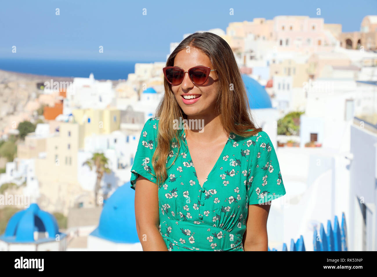 Beautiful smiling girl with sunglasses enjoying summer holidays in Oia, Santorini Stock Photo