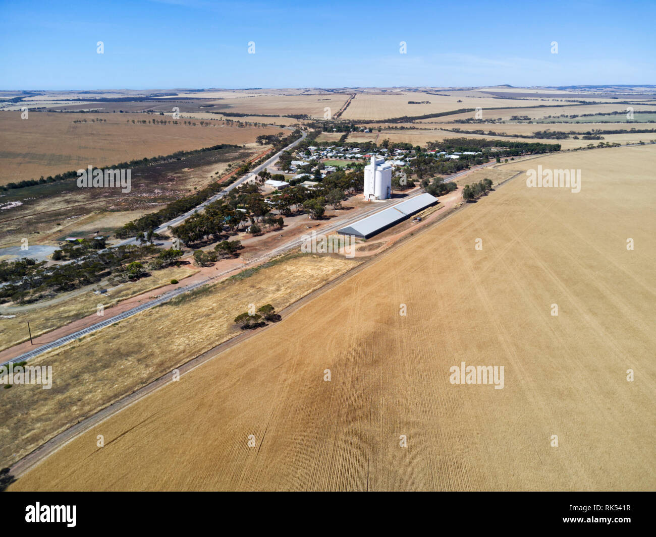 Aerial of rural landscape featuring wheat fields near harvesting time