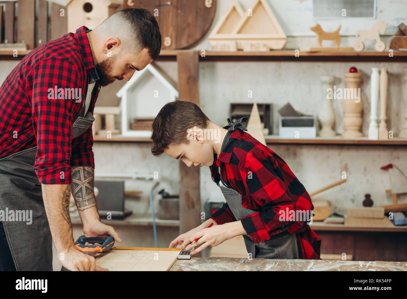 profession, carpentry, woodwork and family concept carpentery