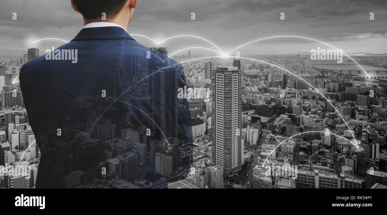Business network technology, logistics and blockchain business. Double exposure businessman with cityscape Stock Photo