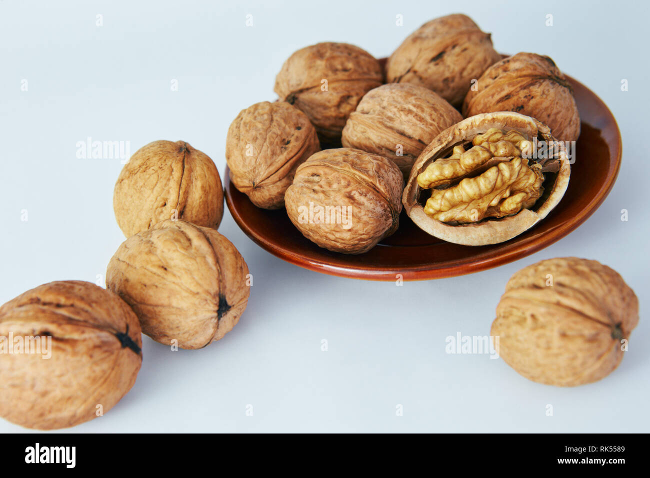 Greek nuts on a white background, lying in a beautiful plate Stock
