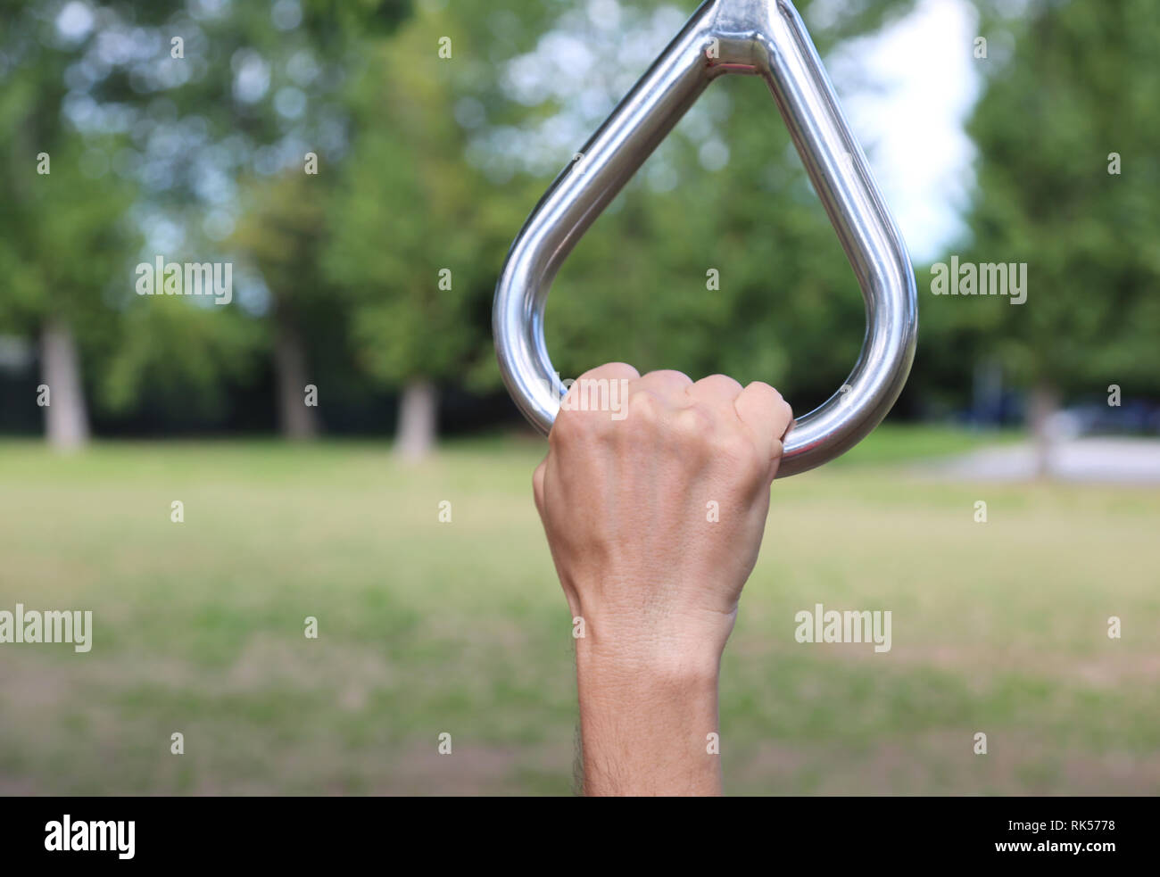 athlete's hand during a gymnastic exercise at the rings in the outdoor