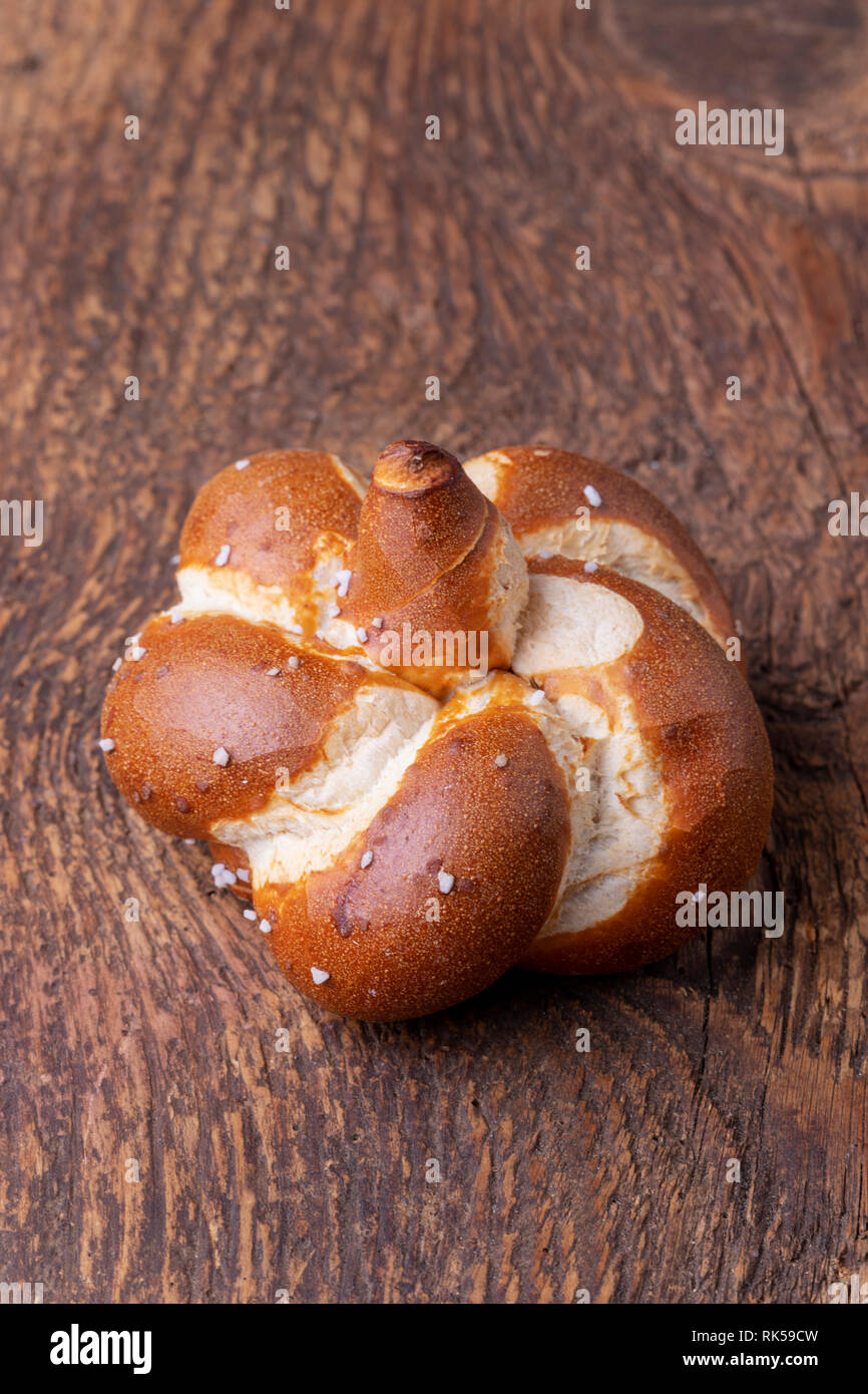 single bavarian pretzel on wood Stock Photo