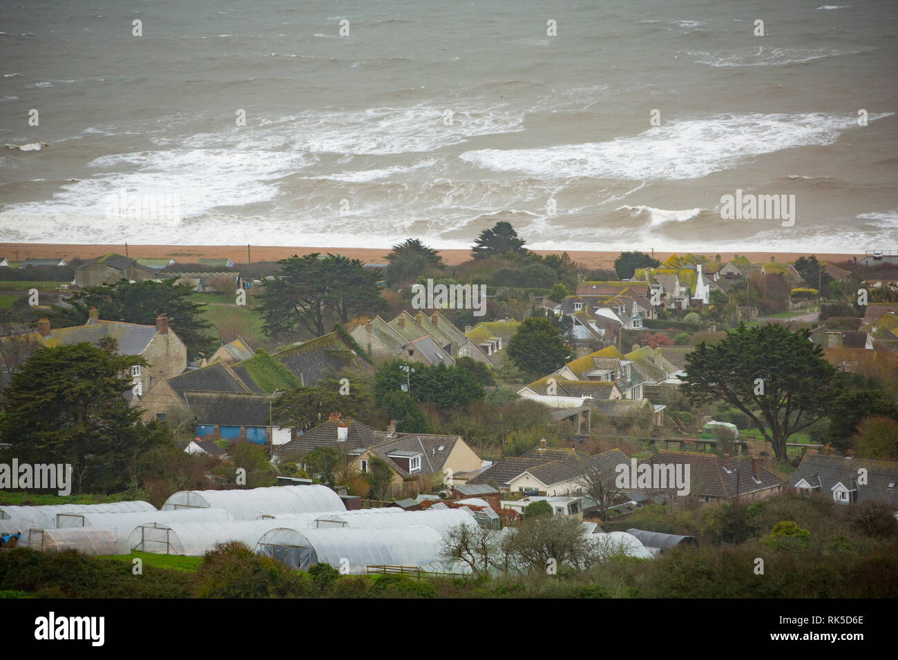 The village of West Bexington overlooking Chesil beach with Storm Erik creating some large waves. Dorset England UK GB. 8.2.2019 Stock Photo