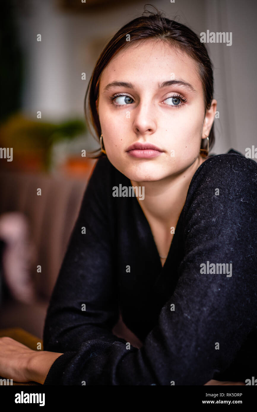 Young Generation Z woman lost in thought Stock Photo