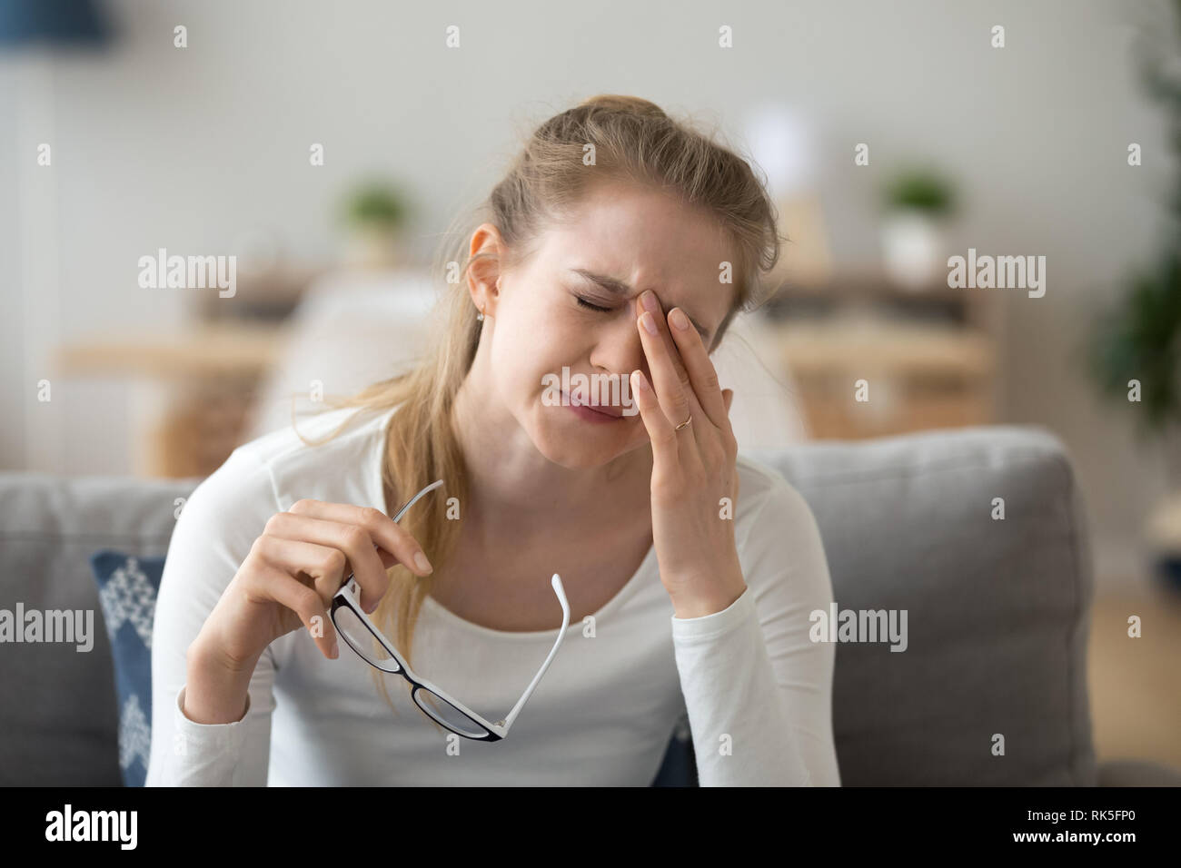 Tired teen girl rubbing eyes feeling eyestrain taking off glasses Stock Photo