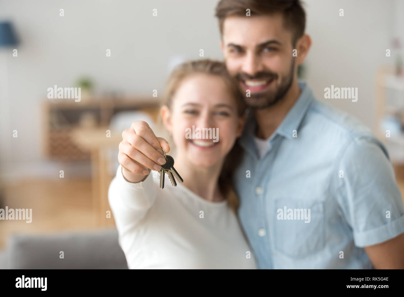 Happy young married family couple holding keys to new flat Stock Photo ...