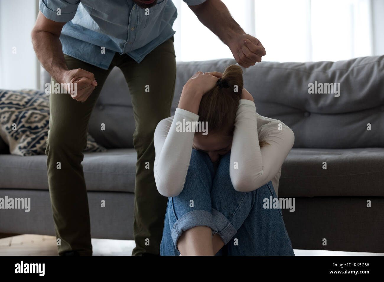 Abusive husband threaten crying wife, fear of domestic violence concept Stock Photo
