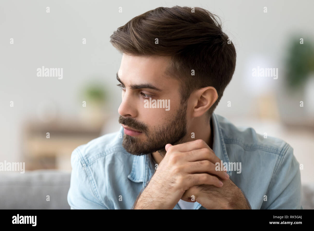 Thoughtful concerned man thinking about problem solution lost in thoughts Stock Photo