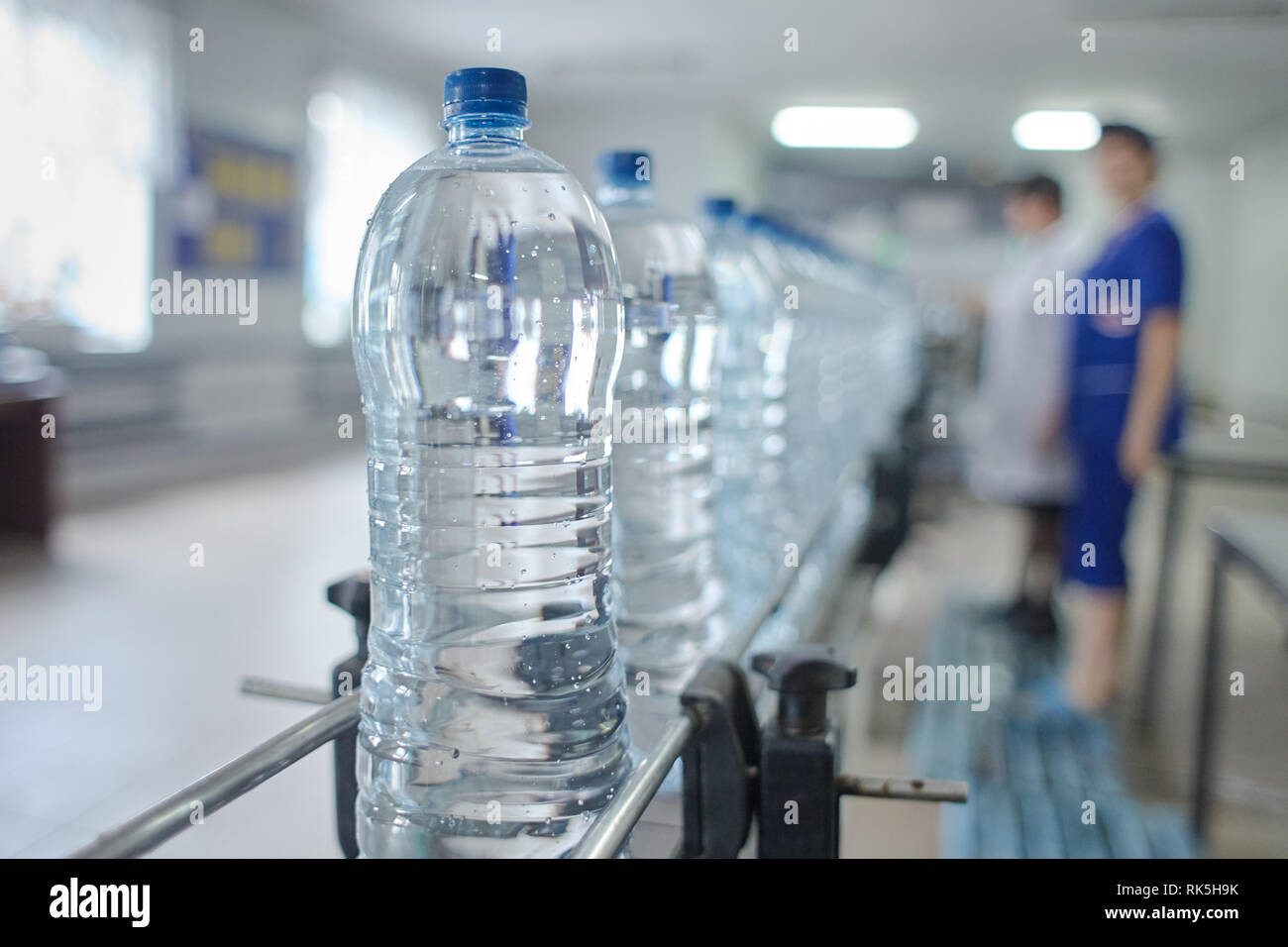 Pet bottle with natural water manufacturing. Soft focus. Stock Photo