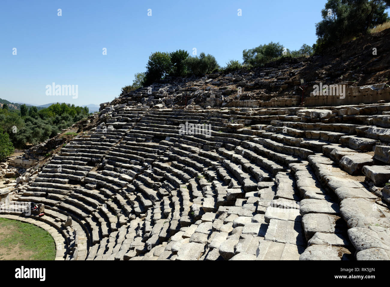 Cavea (seating) of the Hellenistic theatre, built on a natural slope of a hill, ancient Stratonicea, Eskihisar, Turkey. The theatre is of Greek type w Stock Photo