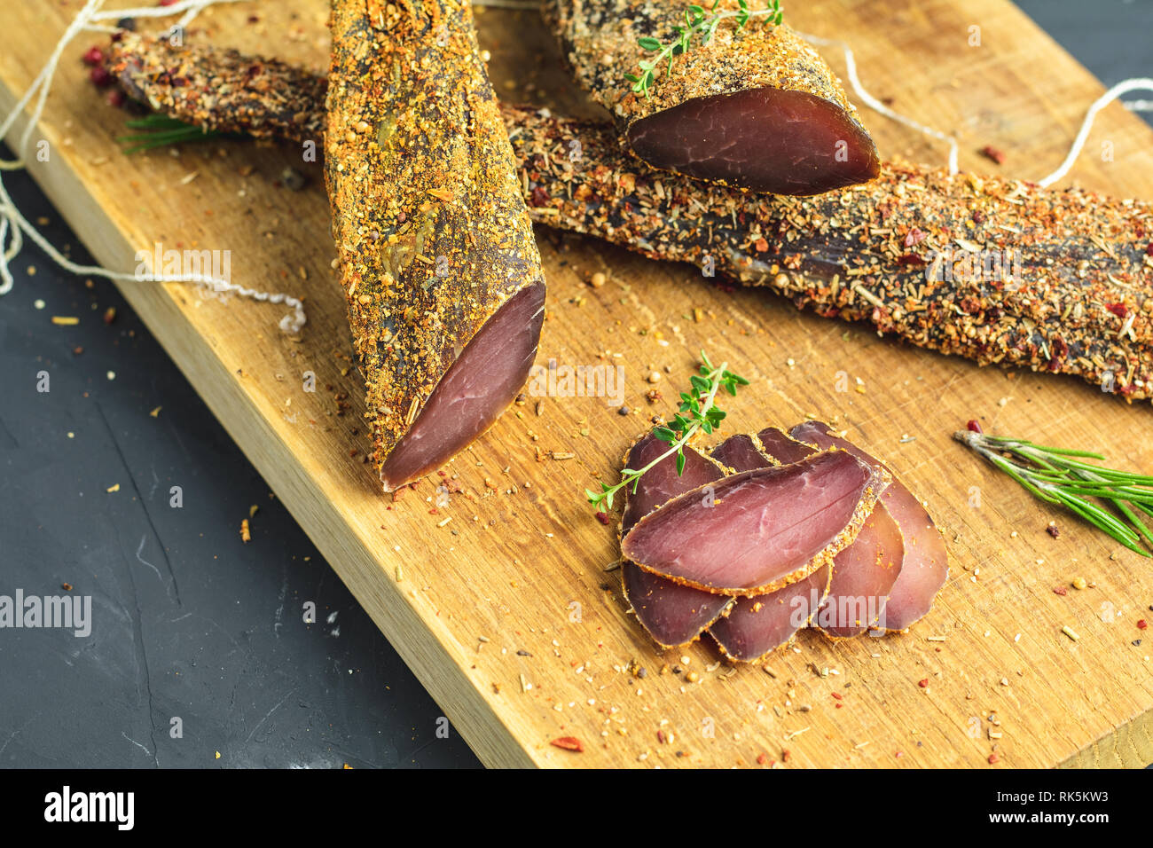 Jerky, basturma, dried meat beef, meat smoked jerky with spices on