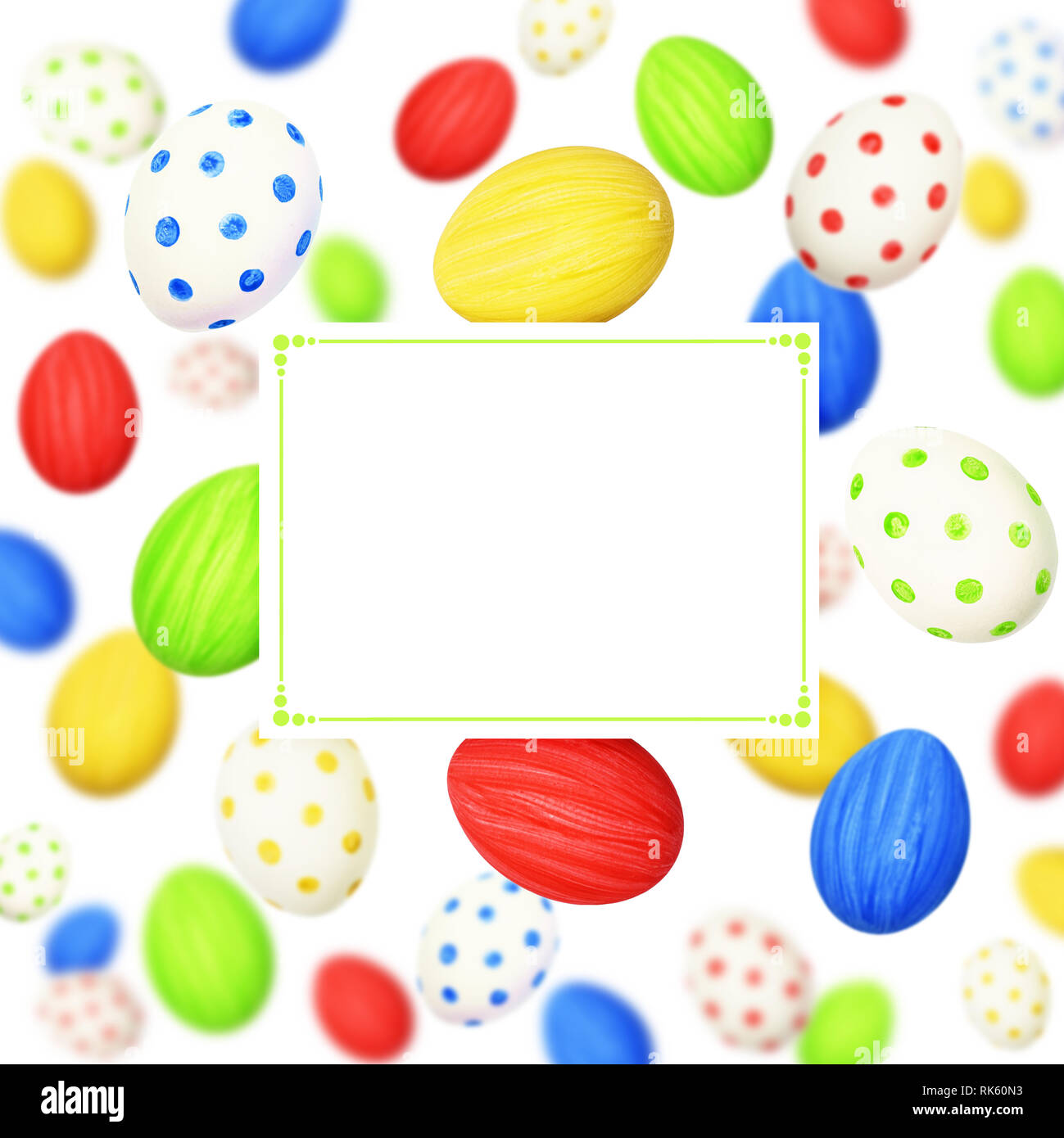 Cololrful Easter eggs scattered on white background and a card Stock Photo