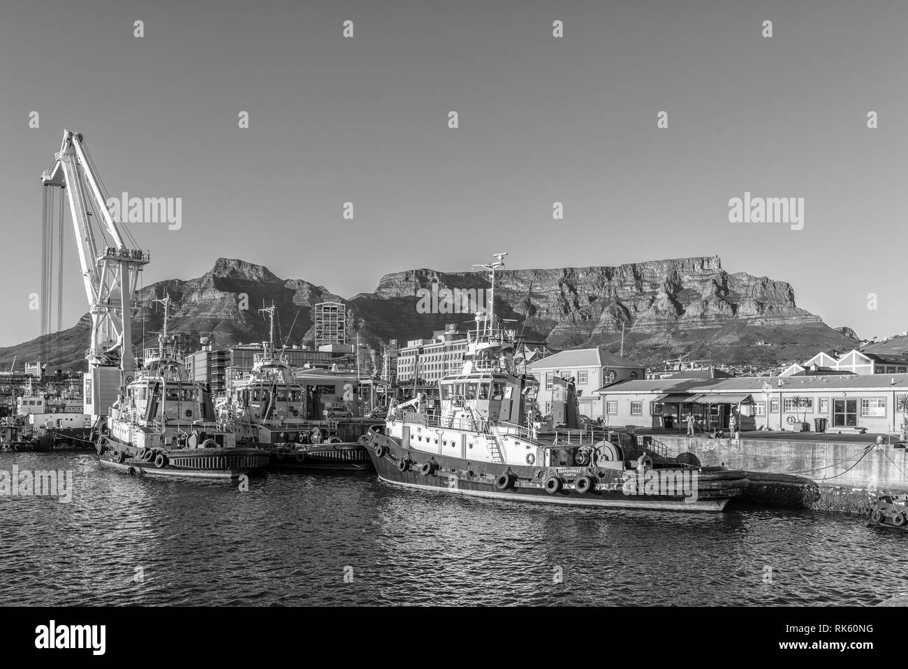 CAPE TOWN, SOUTH AFRICA, AUGUST 9, 2018:  The harbor and the Victoria and Alfred Waterfront in Cape Town in the Western Cape Province. Tugboats, a cra Stock Photo