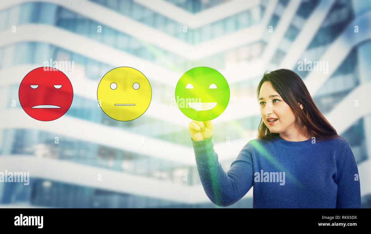 Young woman touching digital screen interface choosing happy emoticon face rating, positive feedback. Excellent customer service concept. Satisfied cl Stock Photo