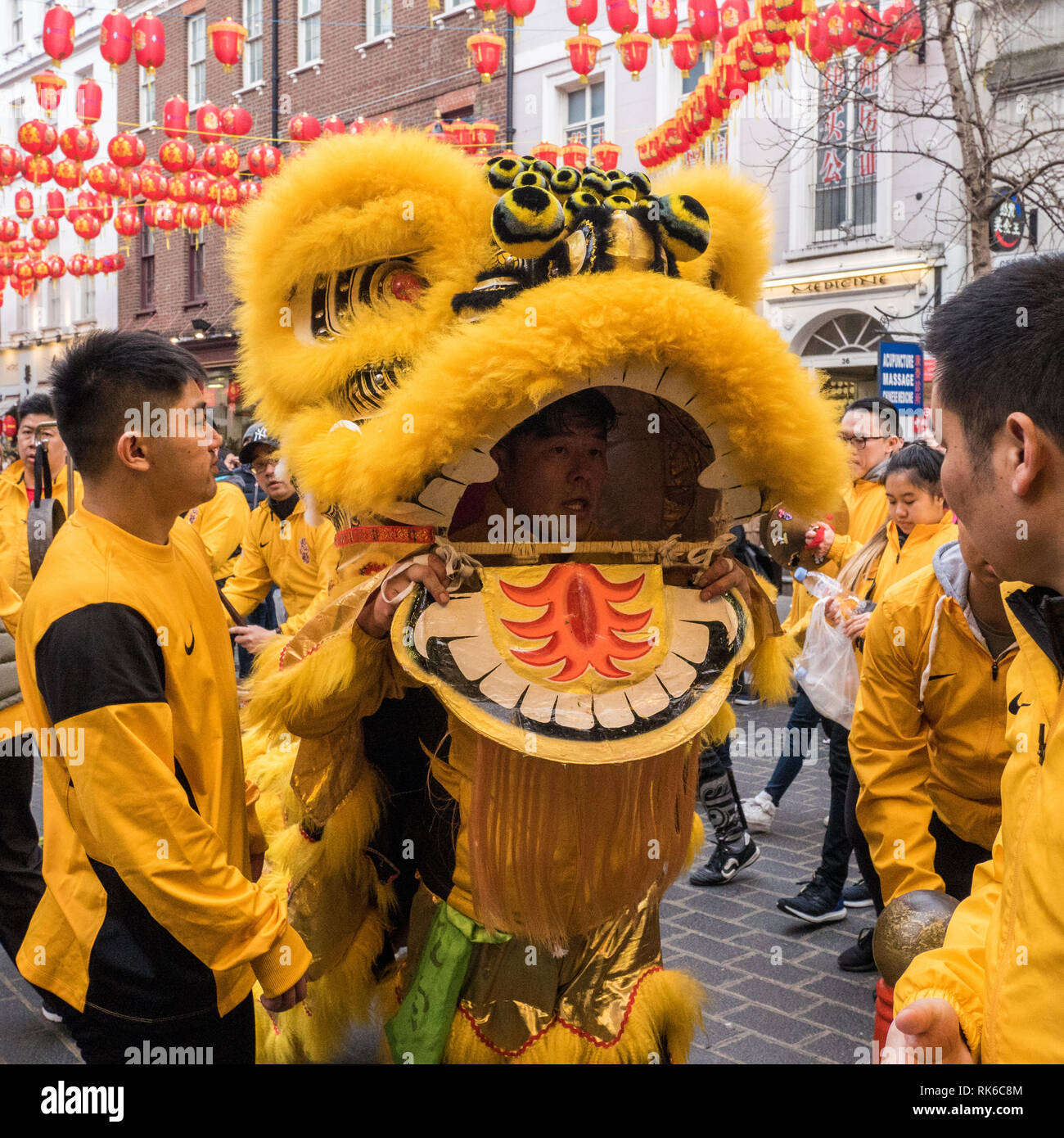 London, UK. 09th Feb, 2019. 'Dragon' entertainer taking a much needed break in between performances as part of the Chinese New Year celebrations in Chinatown, London, UK. Credit: escapetheofficejob/Alamy Live News Stock Photo