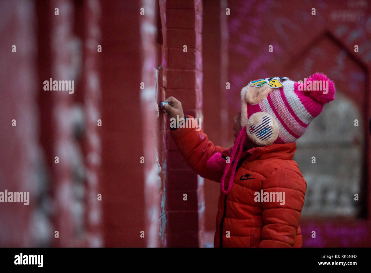 Kathmandu, Nepal. 10th Feb, 2019. A kid writes on a wall at Saraswati Temple during Basanta Panchami early morning in Kathmandu, Nepal, on Feb. 10, 2019. Saraswati, Goddess of Knowledge, is worshipped on this day by the students. Credit: Sulav Shrestha/Xinhua/Alamy Live News Stock Photo