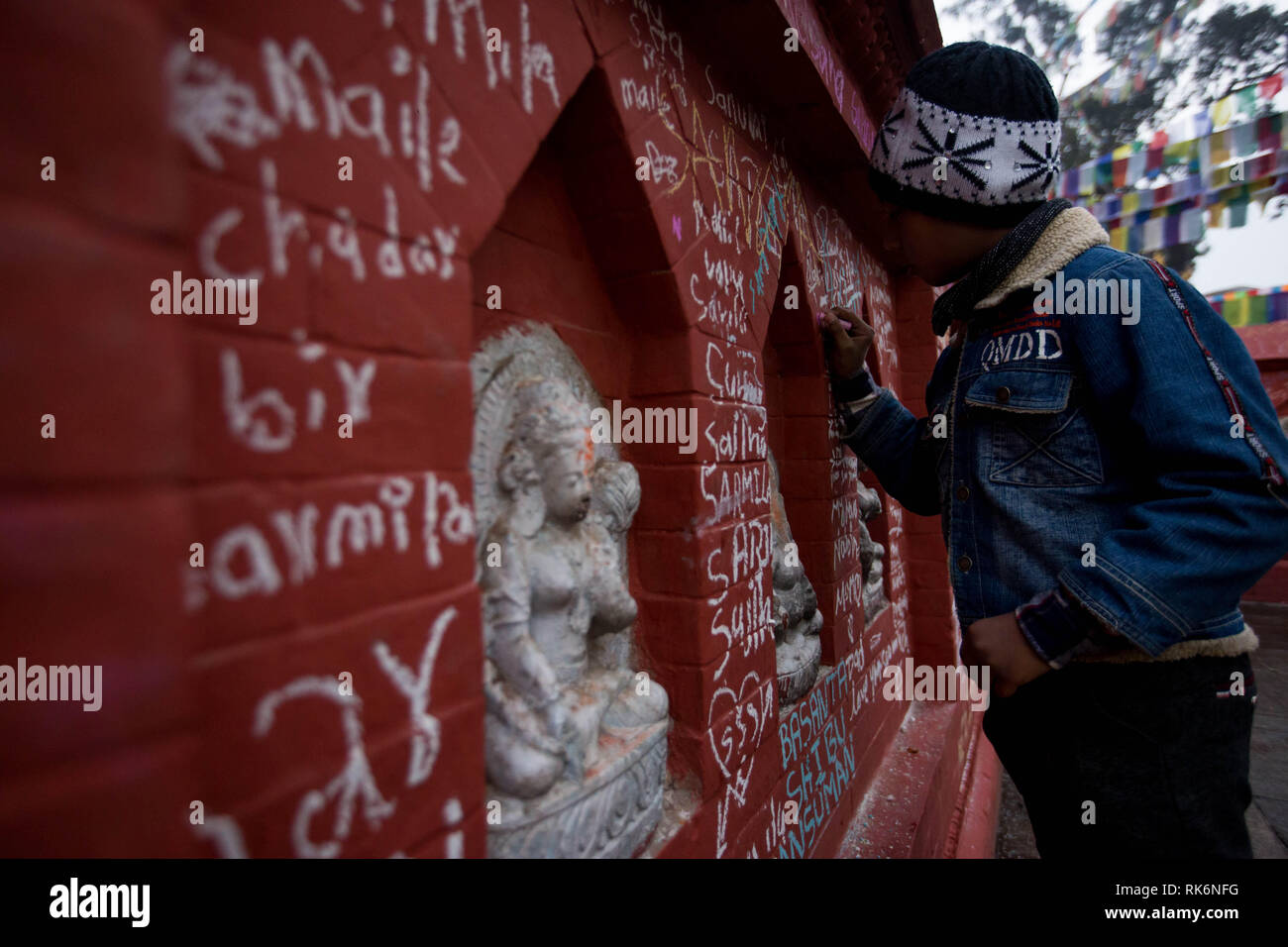 Kathmandu, Nepal. 10th Feb, 2019. A student writes on a wall at Saraswati Temple during Basanta Panchami early morning in Kathmandu, Nepal, on Feb. 10, 2019. Saraswati, Goddess of Knowledge, is worshipped on this day by the students. Credit: Sulav Shrestha/Xinhua/Alamy Live News Stock Photo