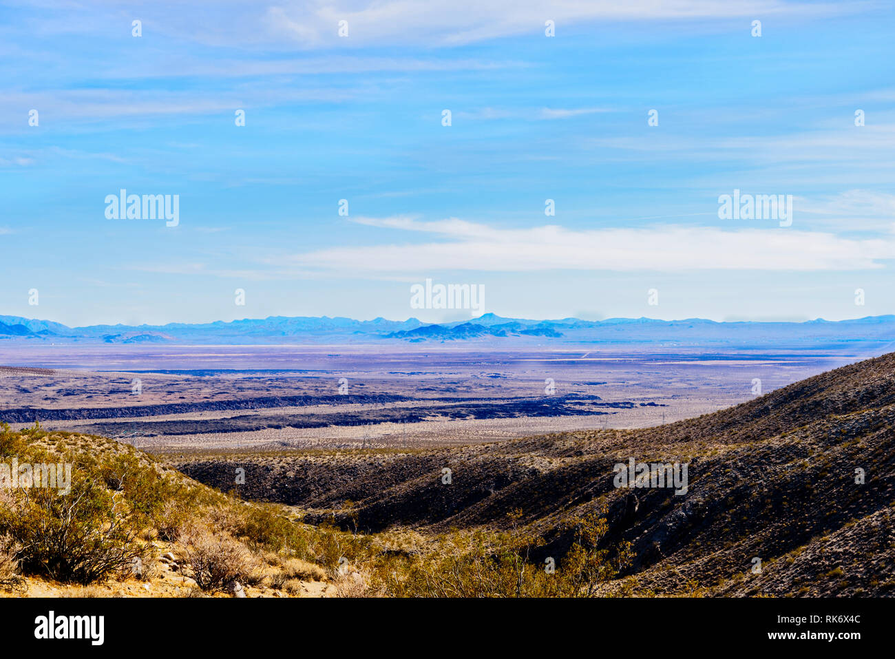 Desert valley landscape under bright blue sky sky with white clouds ...